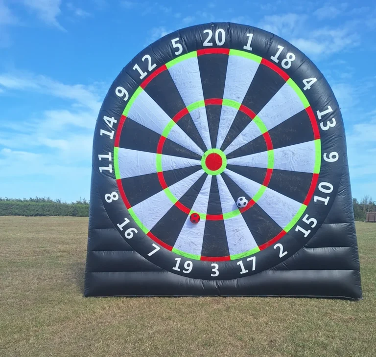 Giant inflatable football dartboard with sticky footballs on the board